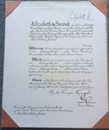 [ELIZABETH II — Excellent OBE Document with her printed signature at the head and his at the foot, | Sophie Dupré Autographs