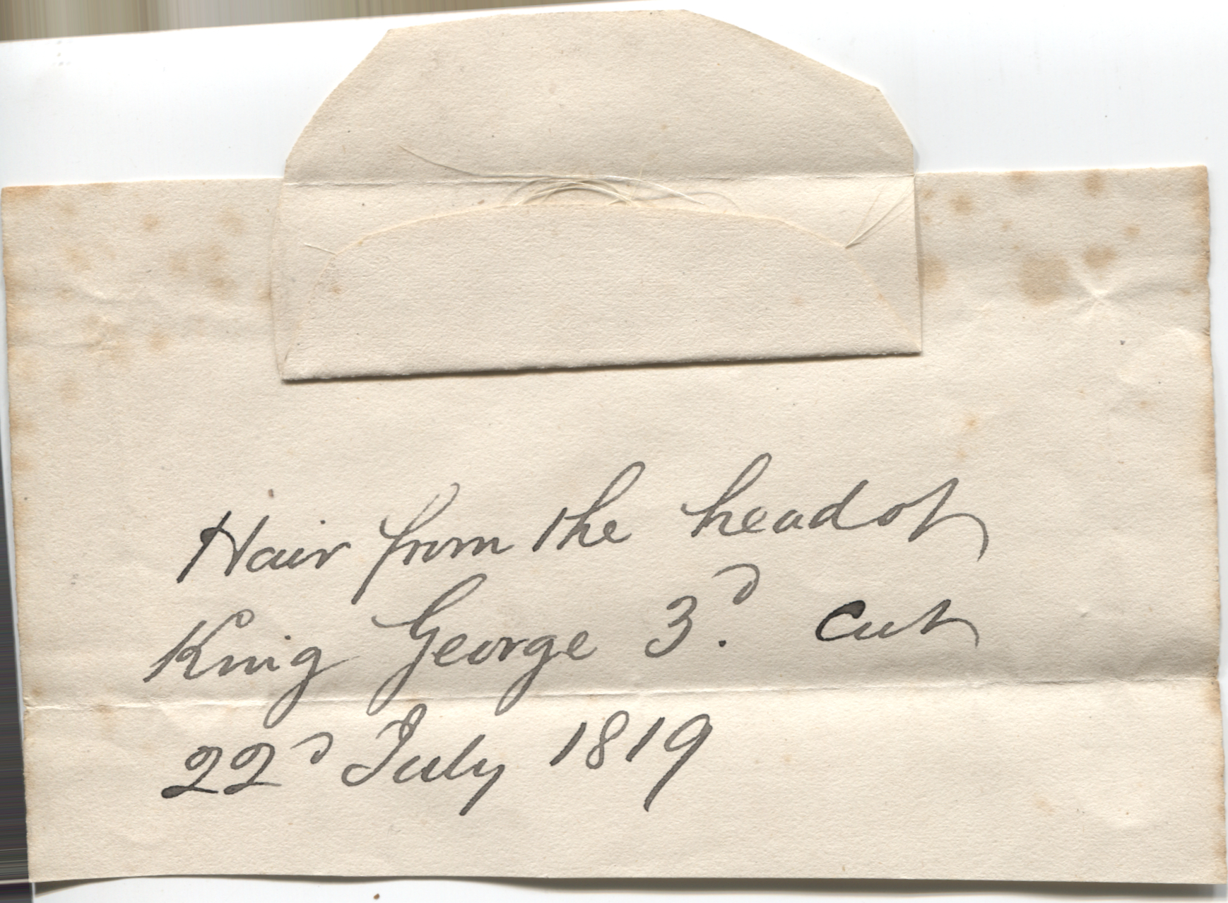 [GEORGE III — Several strands of hair attached to a piece of notepaper with a wrapper with a contemporary annotation | Sophie Dupré Autographs